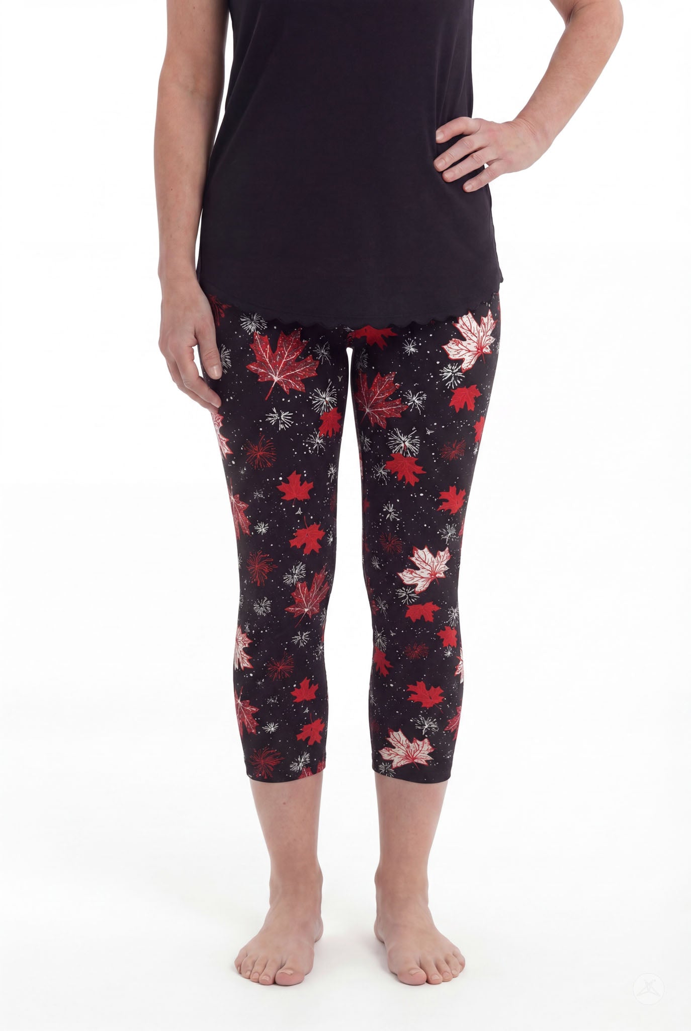 Front view of woman wearing SweetLegs Maple Mood Crops with red and white leaf pattern and black top barefoot