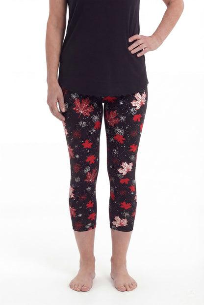 Front view of woman wearing SweetLegs Maple Mood Crops with red and white leaf pattern and black top barefoot