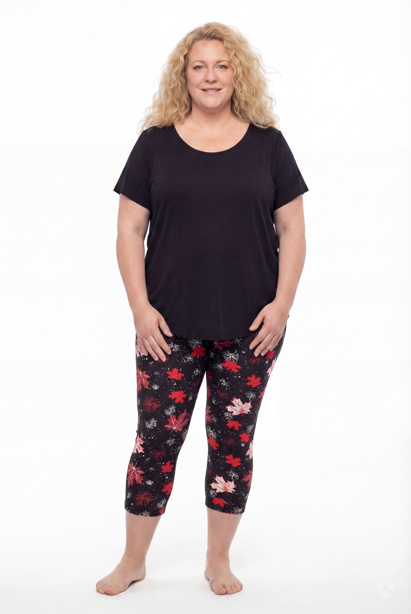Plus size woman wearing SweetLegs Maple Mood Crops with red and white leaf patterns and black short sleeve top barefoot