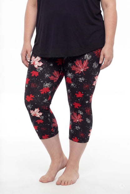 Plus size model wearing SweetLegs Maple Mood Crops with red and white leaf pattern paired with black top barefoot