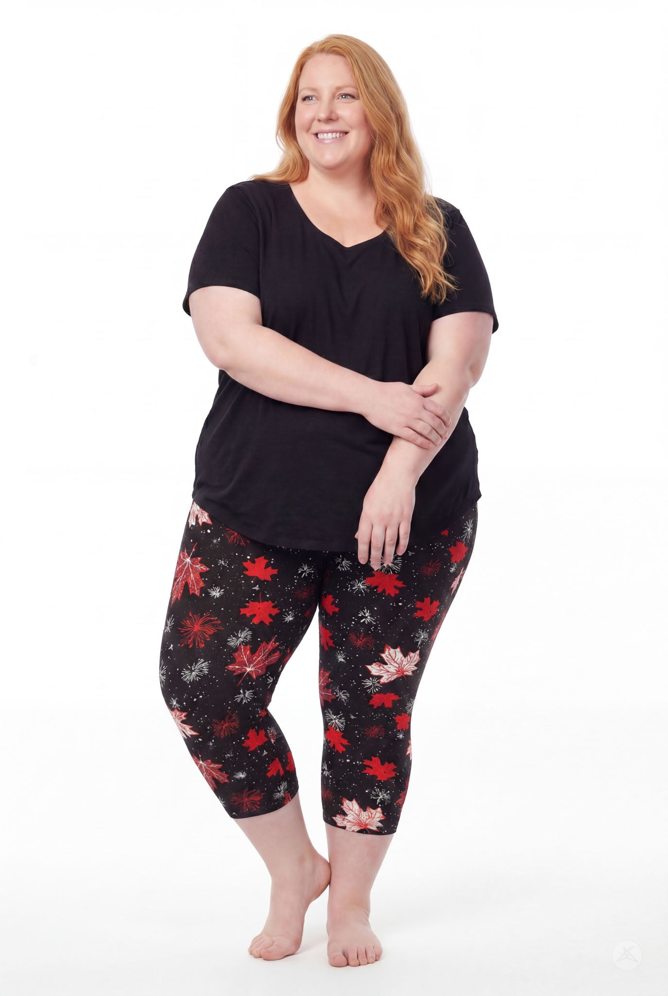 Plus size woman wearing SweetLegs Maple Mood Crops with red and white maple leaf pattern and black top barefoot