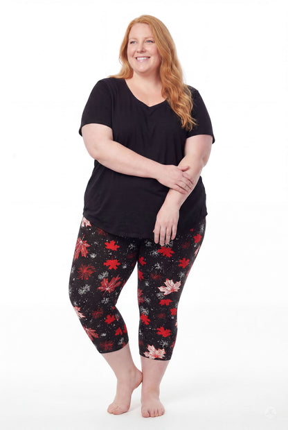 Plus size woman wearing SweetLegs Maple Mood Crops with red and white maple leaf pattern and black top barefoot