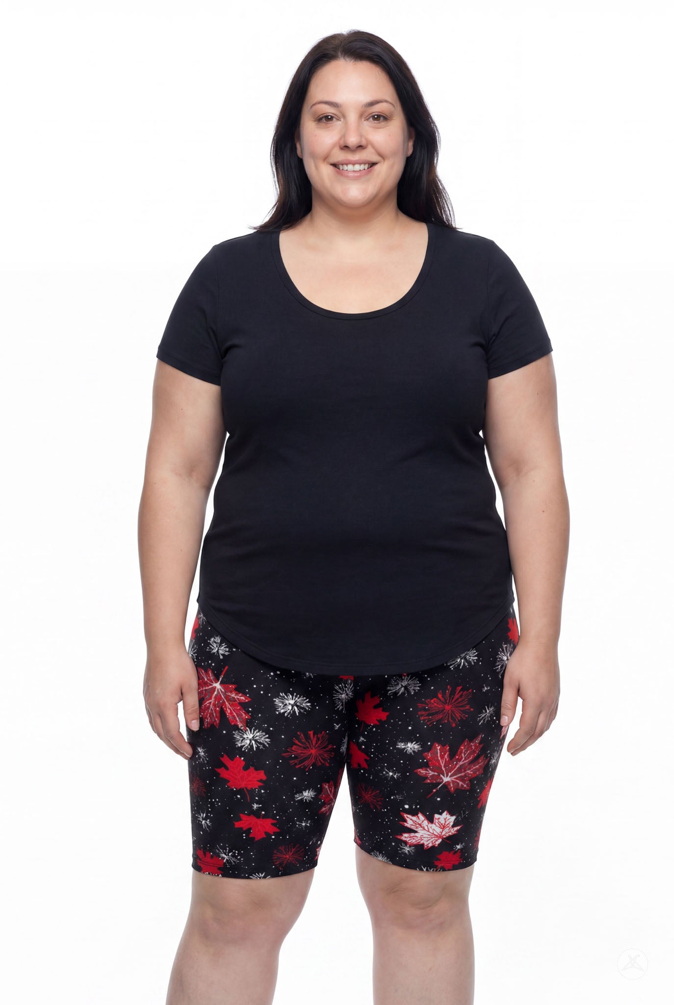 Plus size woman wearing SweetLegs Maple Mood Biker Shorts with red leaf pattern and black top standing front view