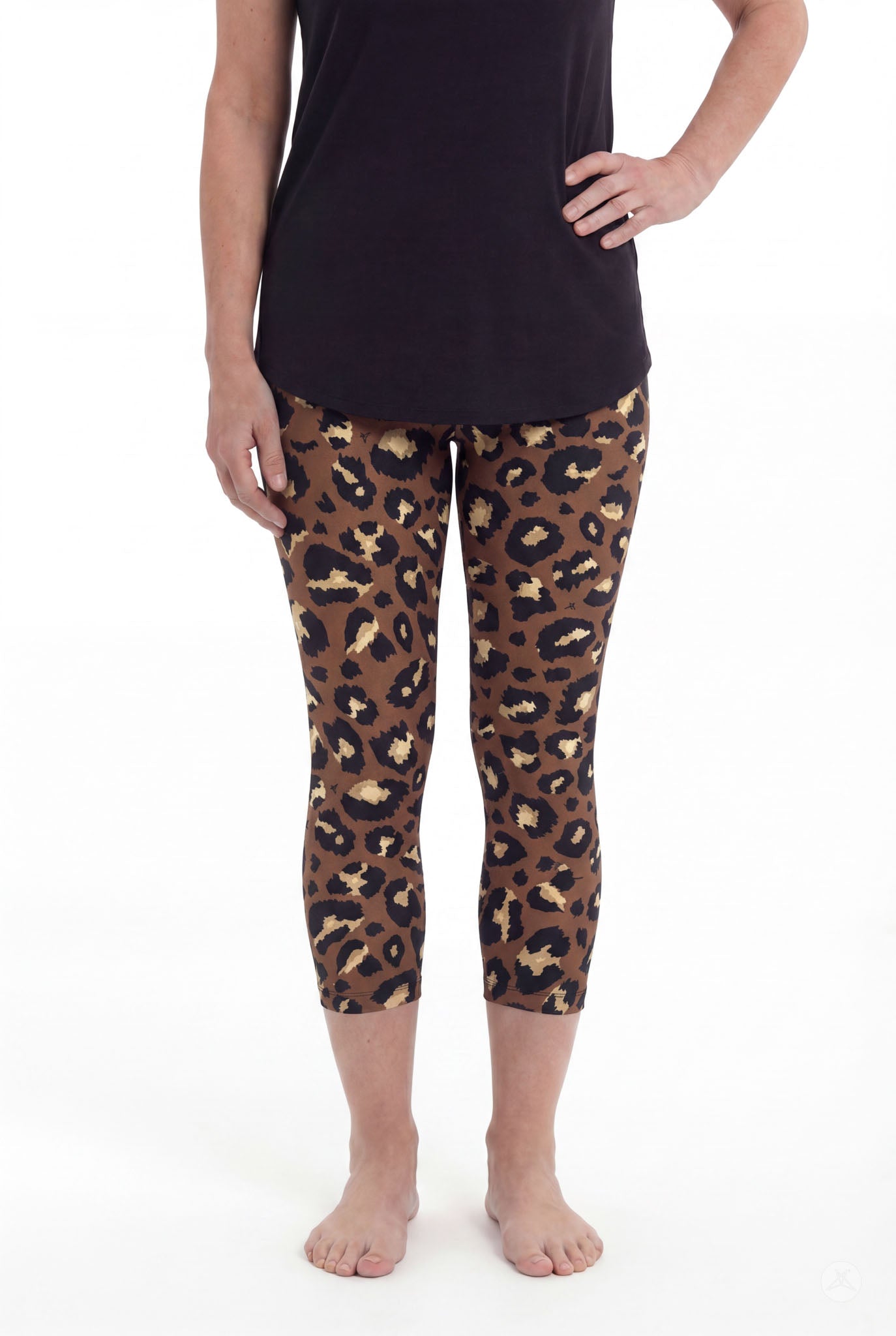 Woman wearing SweetLegs Mocha Spots Crops featuring brown and black leopard print with a black top barefoot