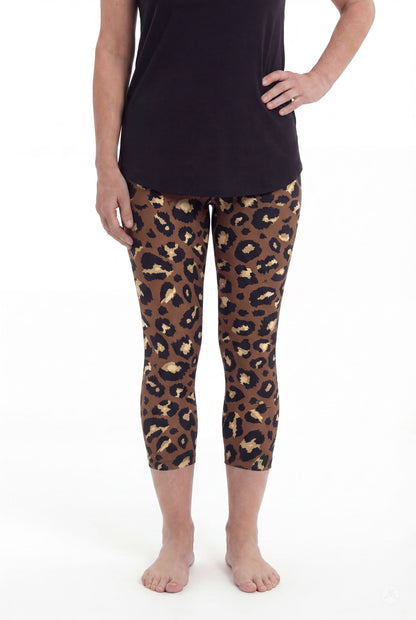 Woman wearing SweetLegs Mocha Spots Crops featuring brown and black leopard print with a black top barefoot