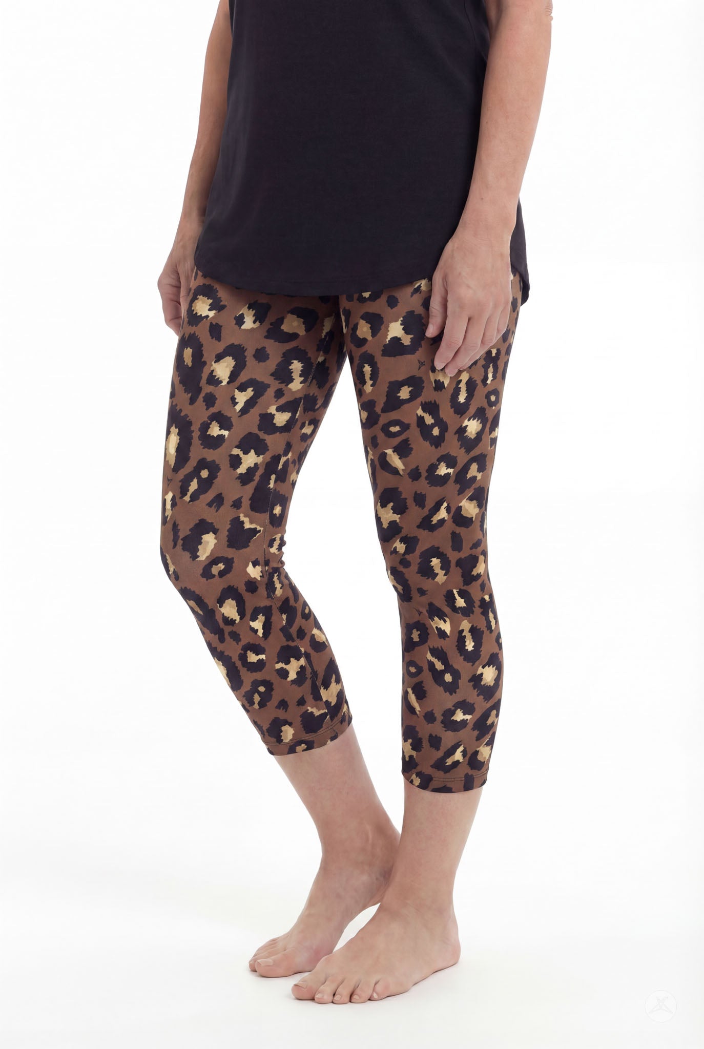 Woman standing barefoot wearing SweetLegs Mocha Spots Crops with brown and black leopard pattern and black top