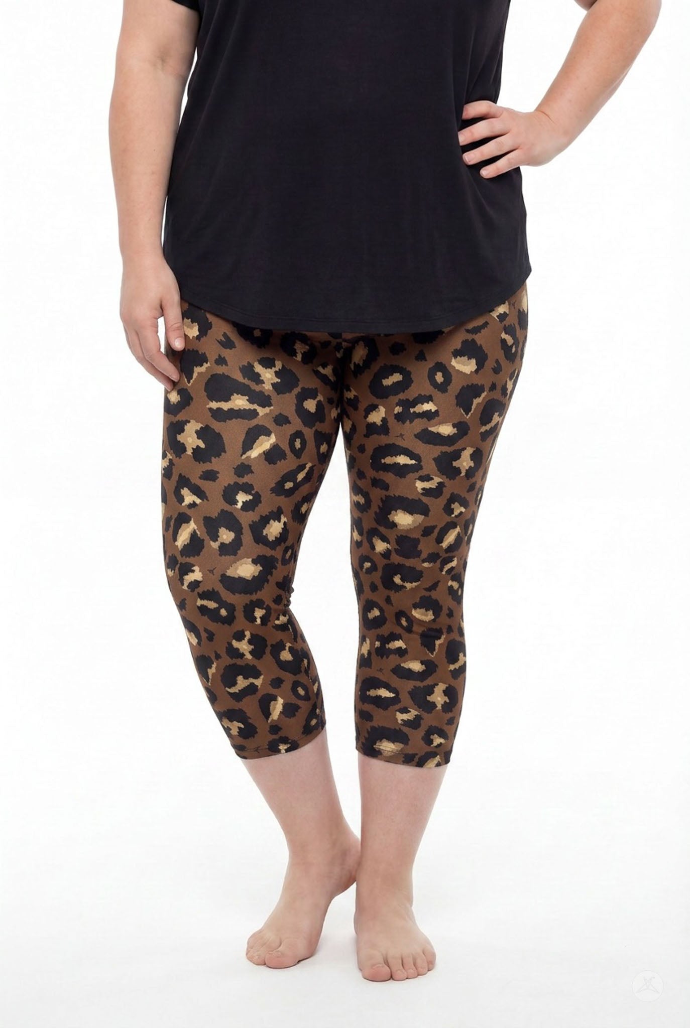 Curvy woman barefoot wearing SweetLegs Mocha Spots Crops with bold brown and tan leopard print and black top