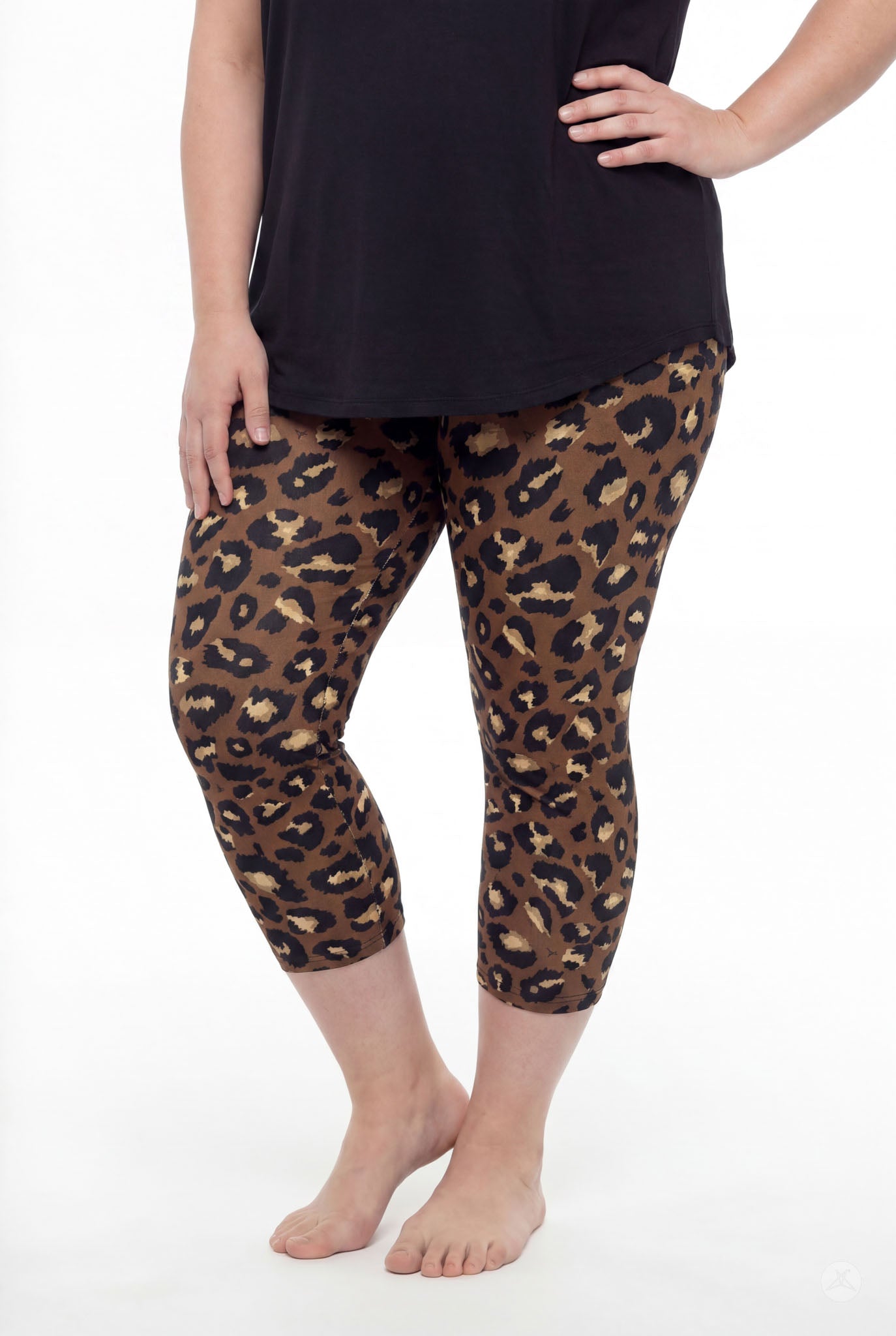 Curvy woman wearing SweetLegs Mocha Spots Crops with bold brown leopard print and black top barefoot standing pose