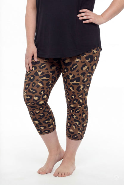 Curvy woman wearing SweetLegs Mocha Spots Crops with bold brown leopard print and black top barefoot standing pose