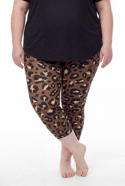Woman wearing SweetLegs Mocha Spots Crops with brown leopard pattern leggings barefoot standing with crossed feet