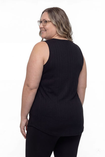 Plus size model wearing The Soft Ribbed Tank in black by SweetTops shown from the back with a relaxed smile