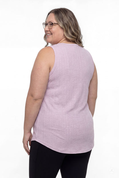 Plus size model wearing SweetTops The Soft Ribbed Tank in lilac shown from the back with black leggings smiling