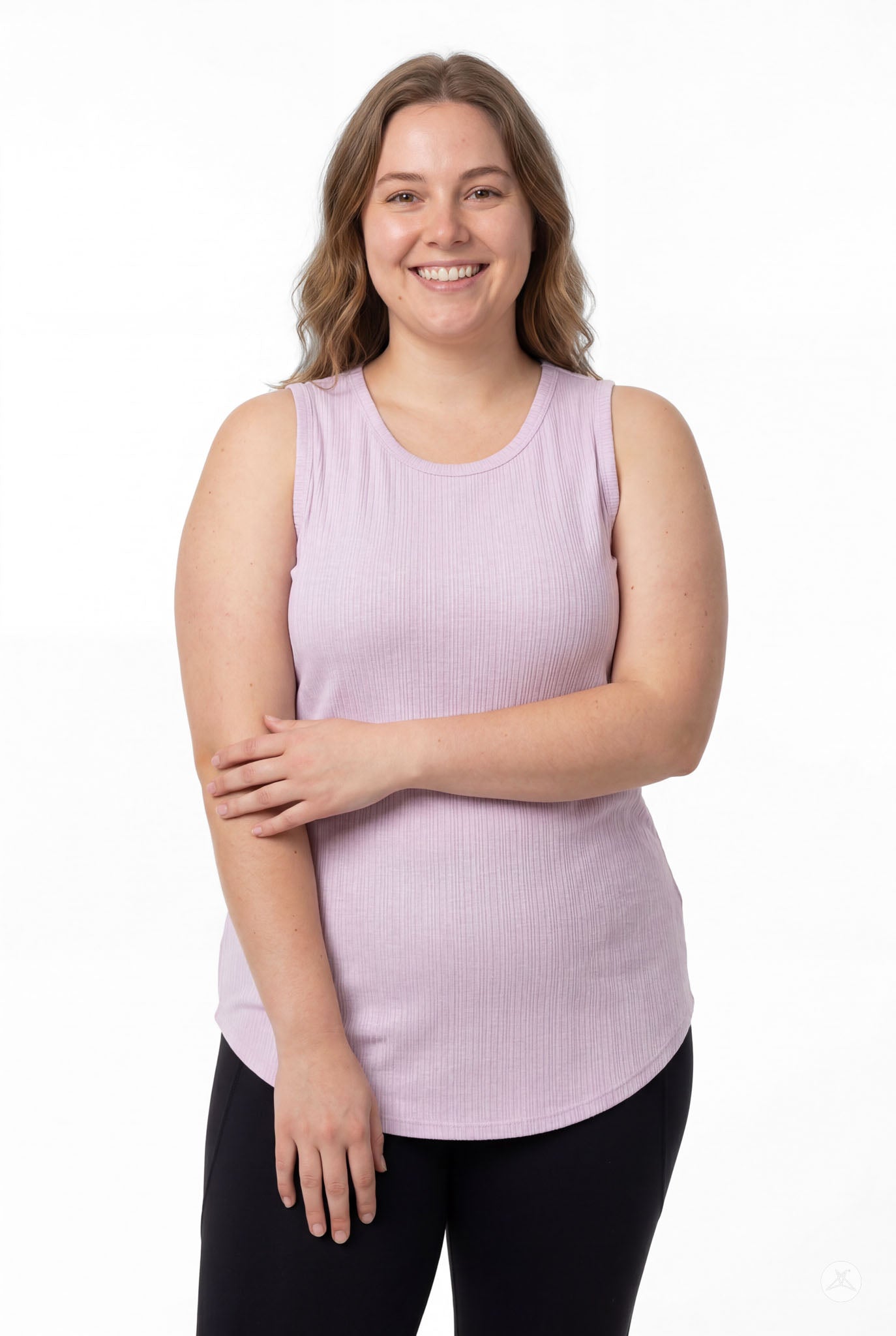 Smiling model wearing SweetTops The Soft Ribbed Tank in lilac, front view with black leggings and relaxed pose