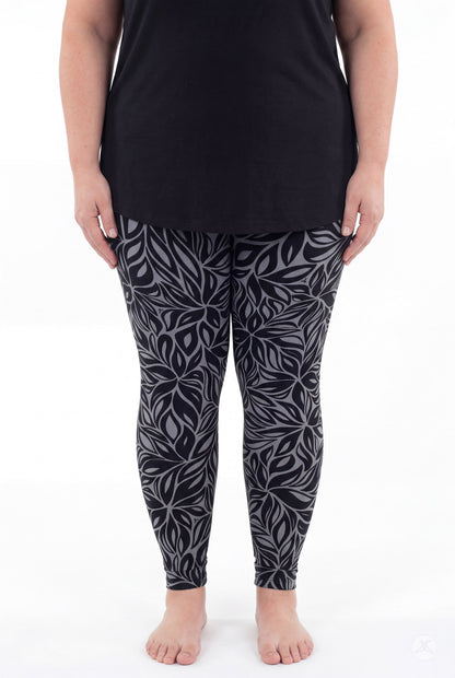 SweetLegs Shadow Petal Leggings modeled by a woman in a black and gray leafy pattern
