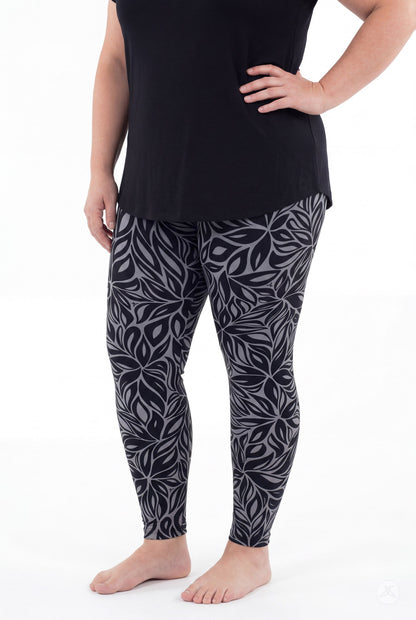 SweetLegs Shadow Petal Leggings worn by a model in a black and gray botanical leaf print