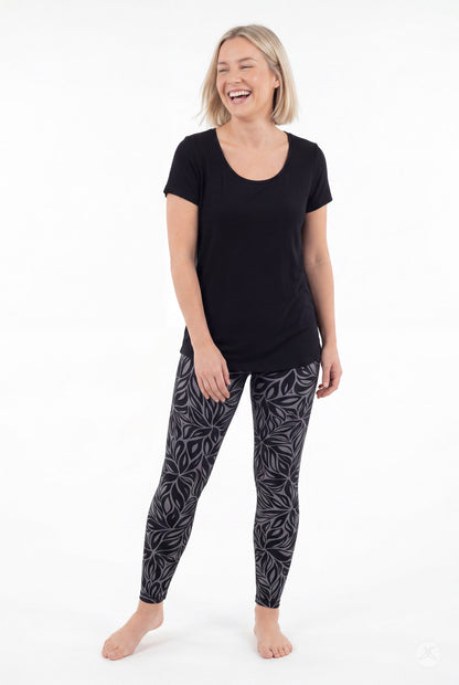 SweetLegs Shadow Petal Leggings worn by a woman in a black and gray leafy pattern