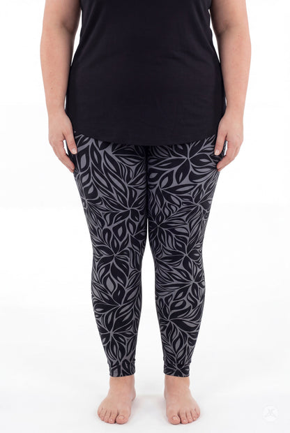 SweetLegs Shadow Petal Leggings shown on a model with a dark botanical leaf print