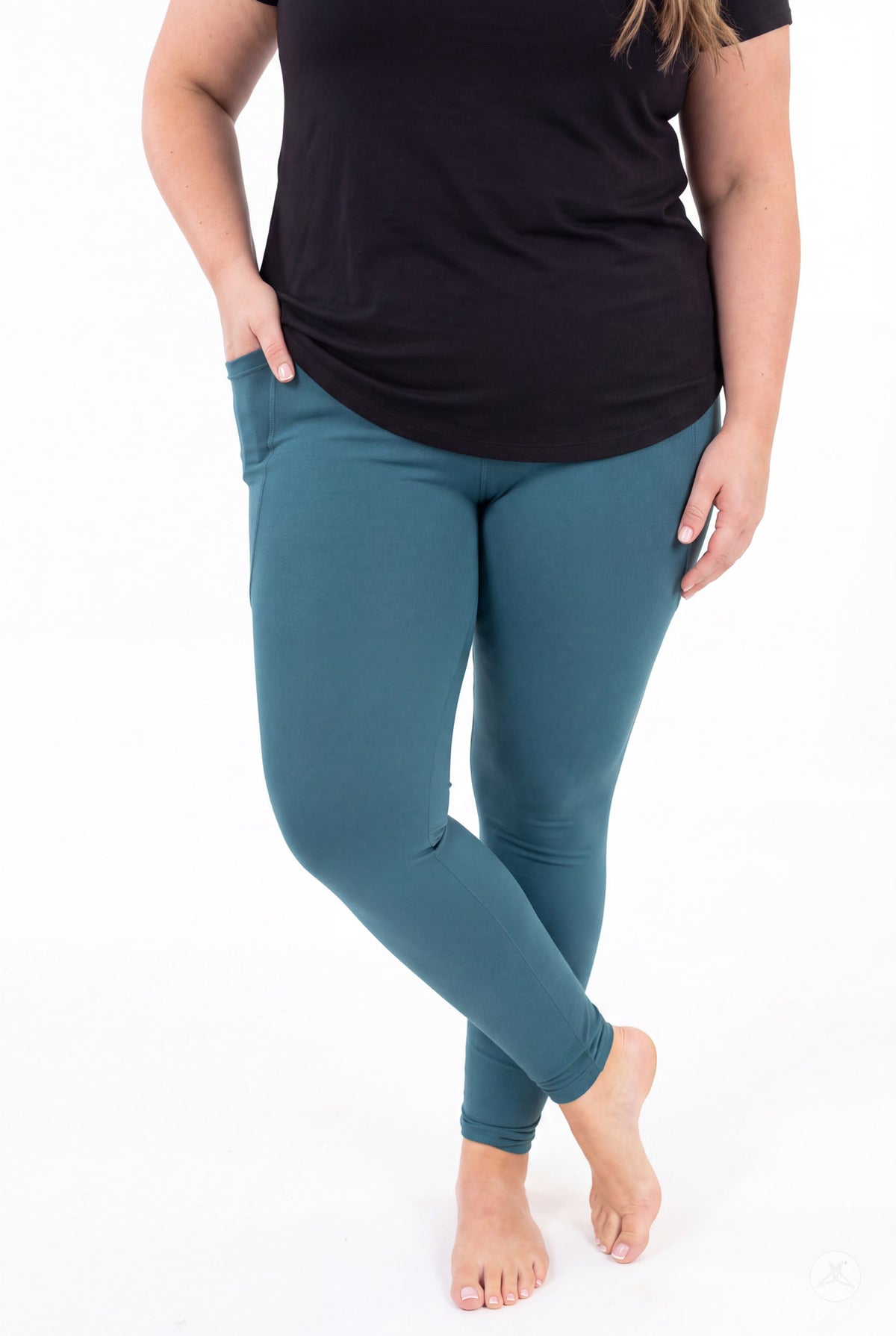 SweetLegs Deep Teal Pocket Leggings worn by a model in a black top with crossed ankles