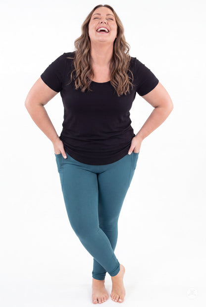 SweetLegs Deep Teal Pocket Leggings worn by a smiling model with crossed ankles