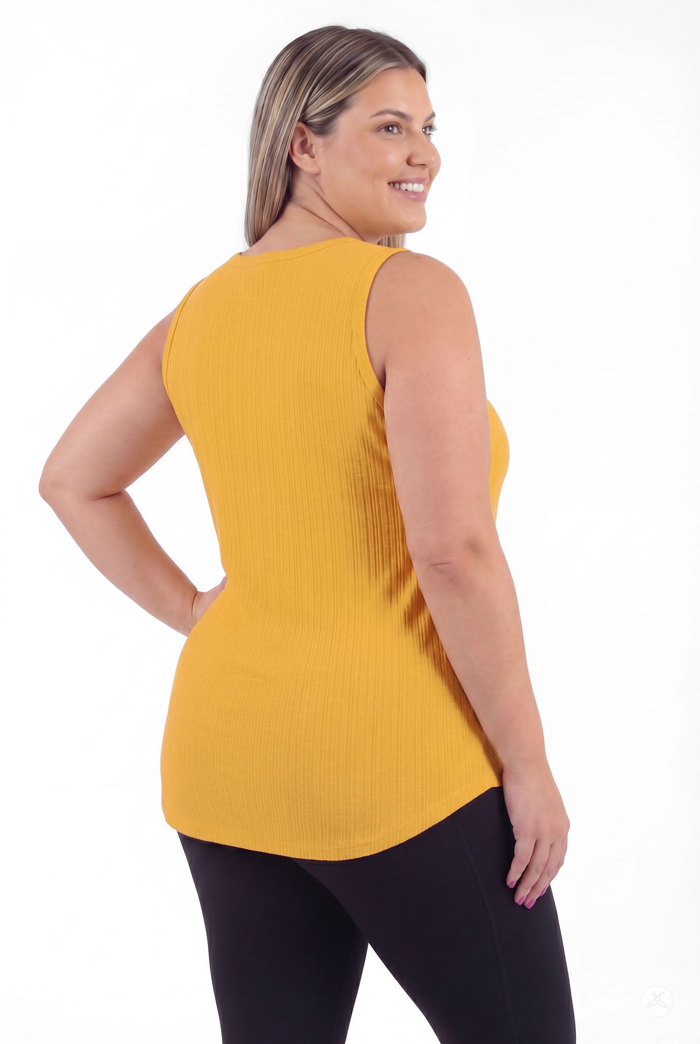 Plus size model smiling wearing The Soft Ribbed Tank in warm marigold by SweetTops showing back and ribbed texture