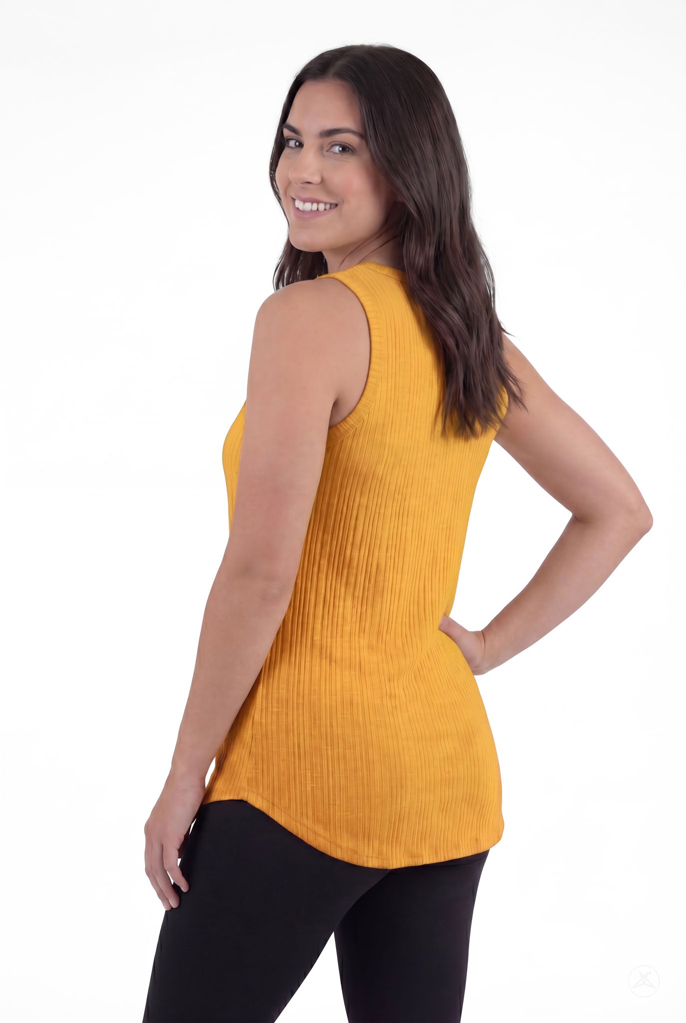 Woman smiling wearing The Soft Ribbed Tank in mustard yellow by SweetTops showing ribbed texture and sleeveless back view