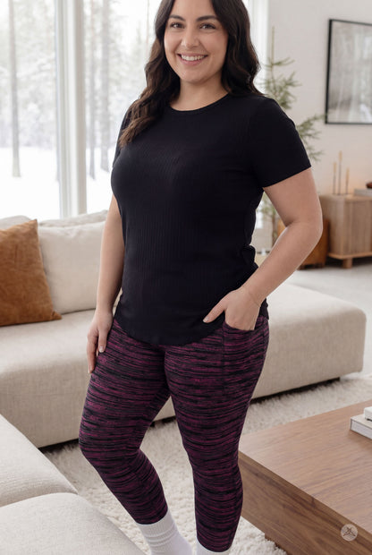 Woman wearing sweetlegs canada The Soft Ribbed Tee standing in a bright living room with hands at sides