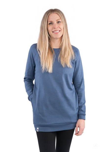 Woman wearing a blue Basic Raglan Pullover (Copy) by SweetLegs Canada standing and smiling against white background