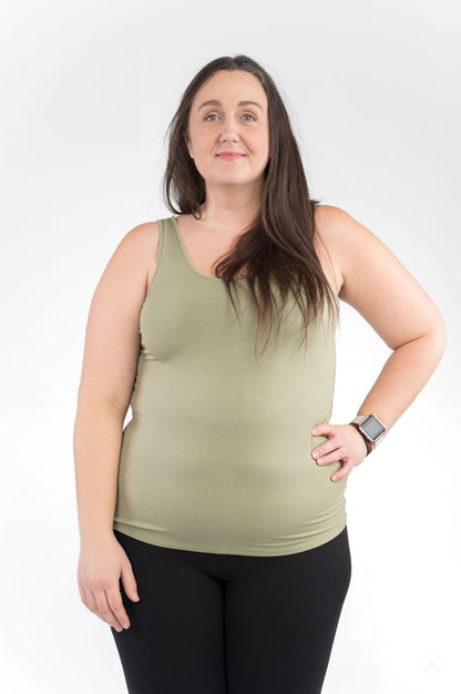 Plus size woman wearing olive green Classic Tank Copy by SweetLegs Canada with black leggings on white background