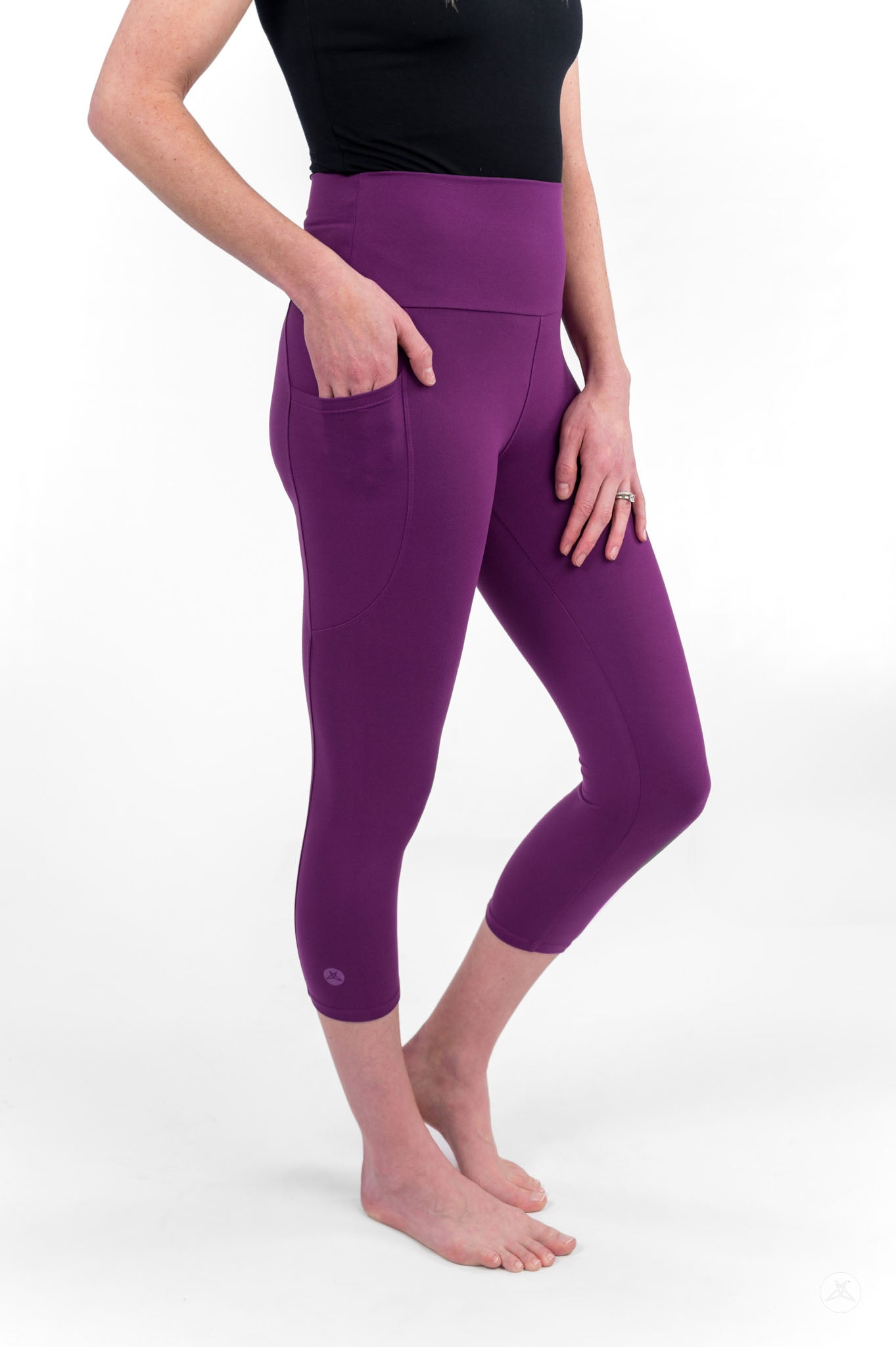 Woman standing barefoot wearing sweetlegs Deep Plum High-Waisted Pocket Crops with side pockets and black sleeveless top