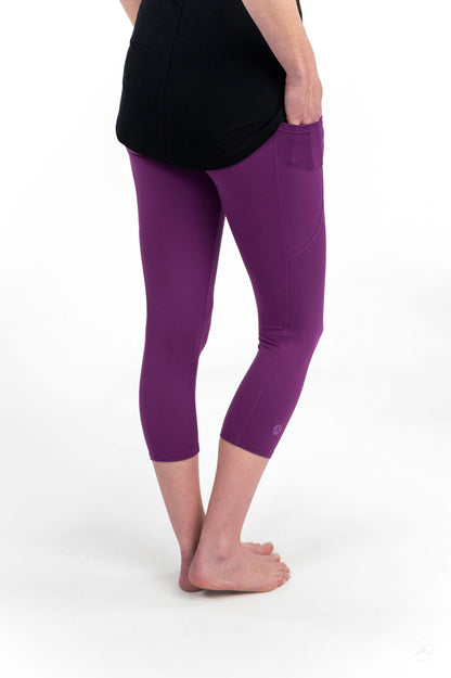 Woman wearing sweetlegs Deep Plum Pocket Crops with side pocket, shown from back against white background