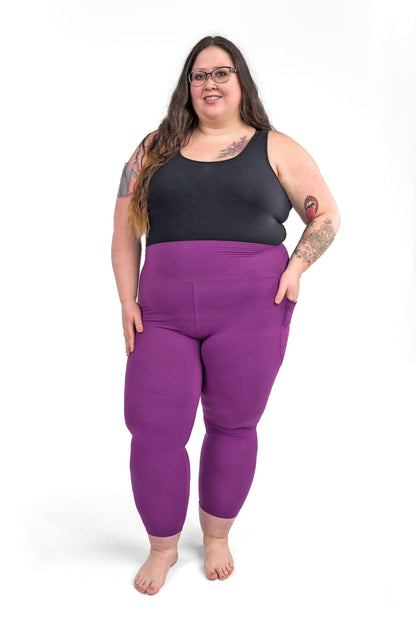 Plus size model wearing sweetlegs Deep Plum High-Waisted Pocket Crops with black tank top on white background