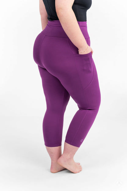 Plus size model wearing Deep Plum High-Waisted Pocket Crops by sweetlegs shown from back with hand in side pocket