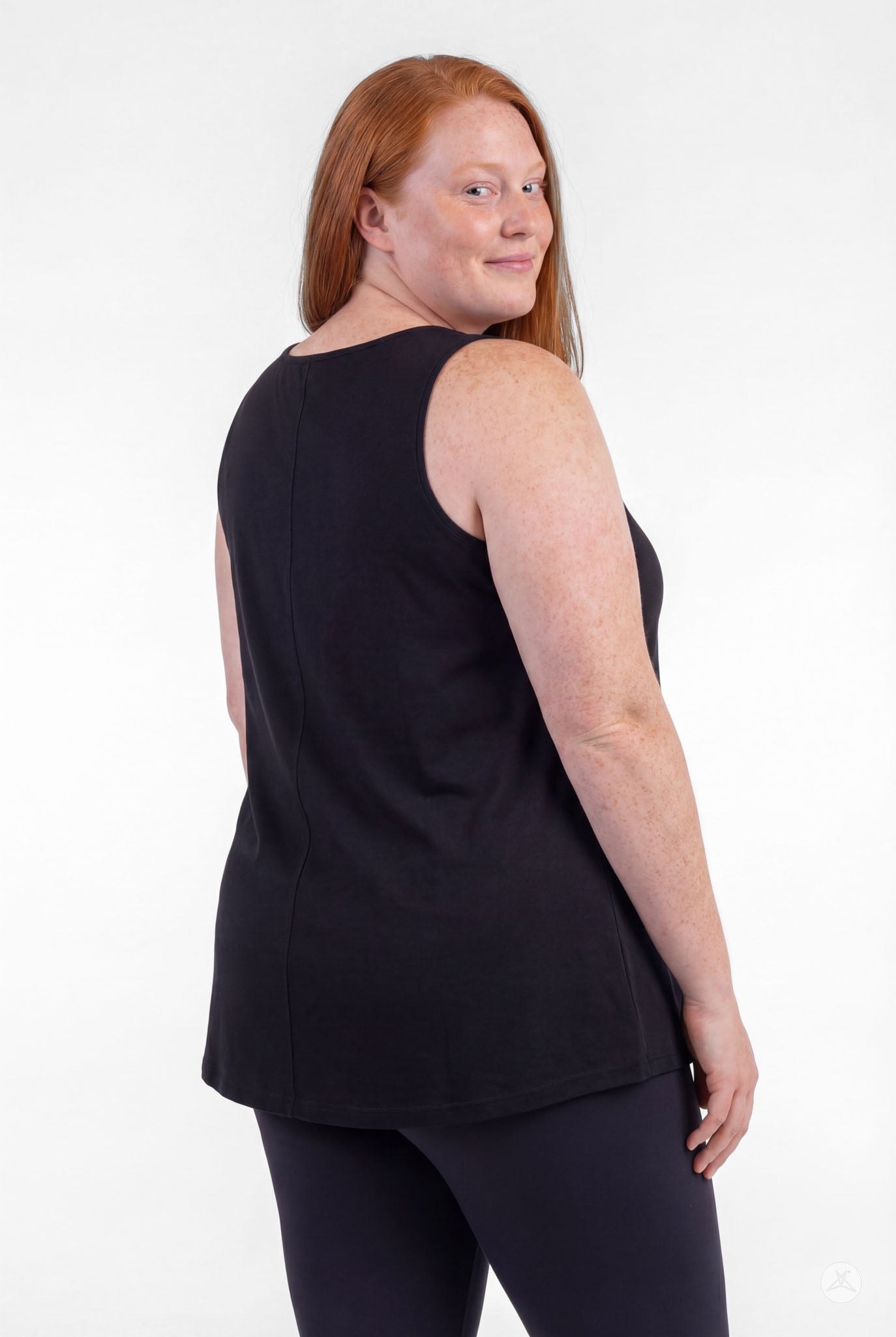 Plus size model wearing sleeveless black High Neck Tank by sweettops shown from back on white background