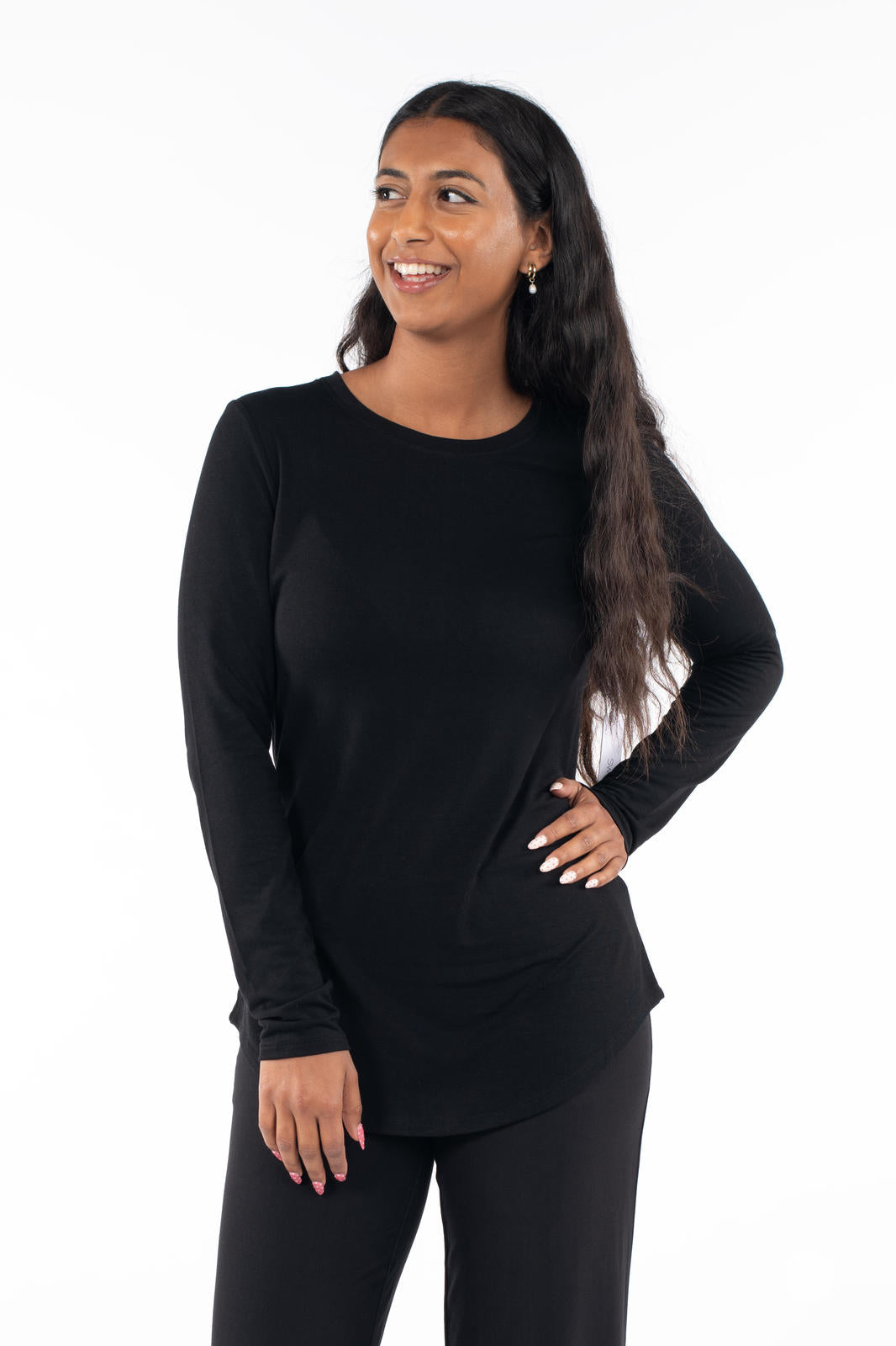 Woman smiling wearing a black Crew Neck Long Sleeve by SweetLegs Canada with a fitted cut and relaxed hem