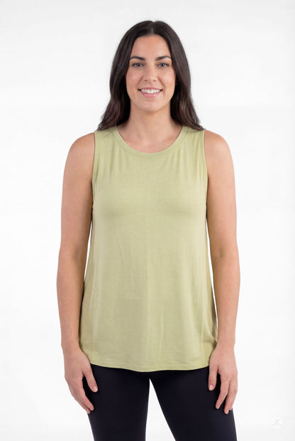 Woman wearing light green sleeveless High Neck Tank by sweettops smiling against white background