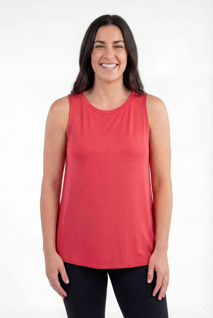 Smiling woman modeling red sleeveless High Neck Tank by sweettops standing casually against white background