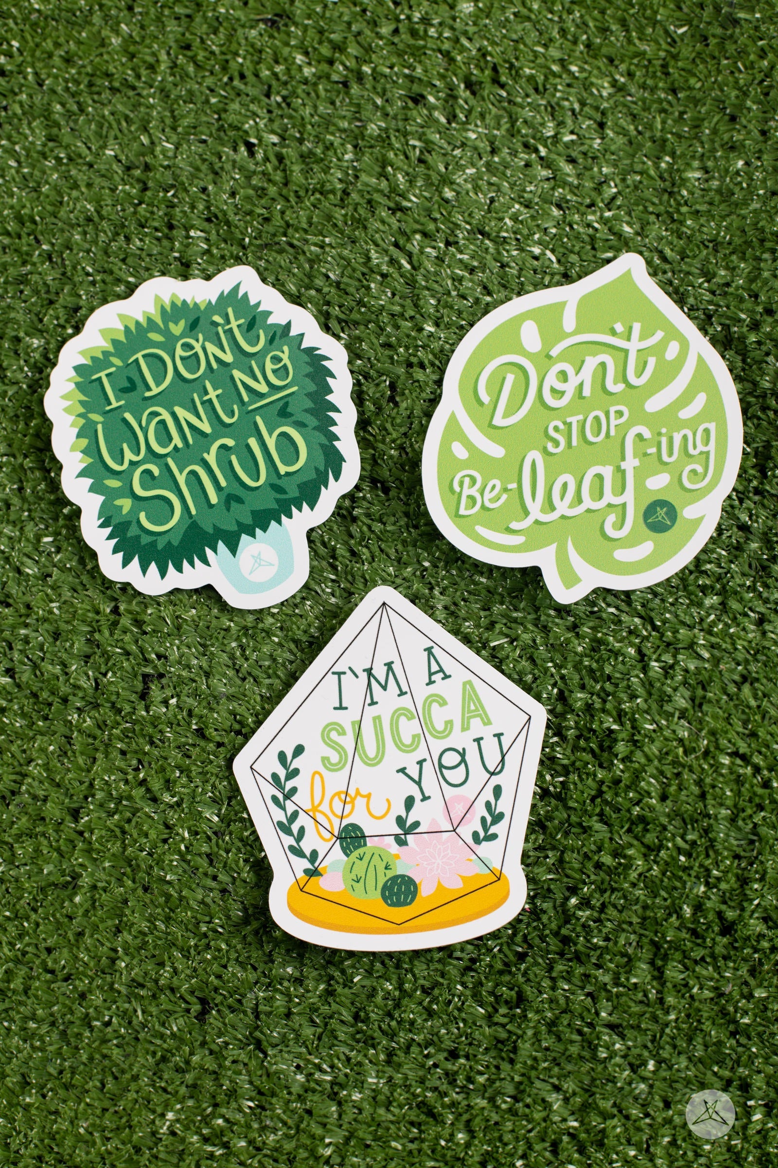 Three nature-themed stickers on grass including "I'm A Succa For You Sticker Pack" by sweetlegs with leafy designs