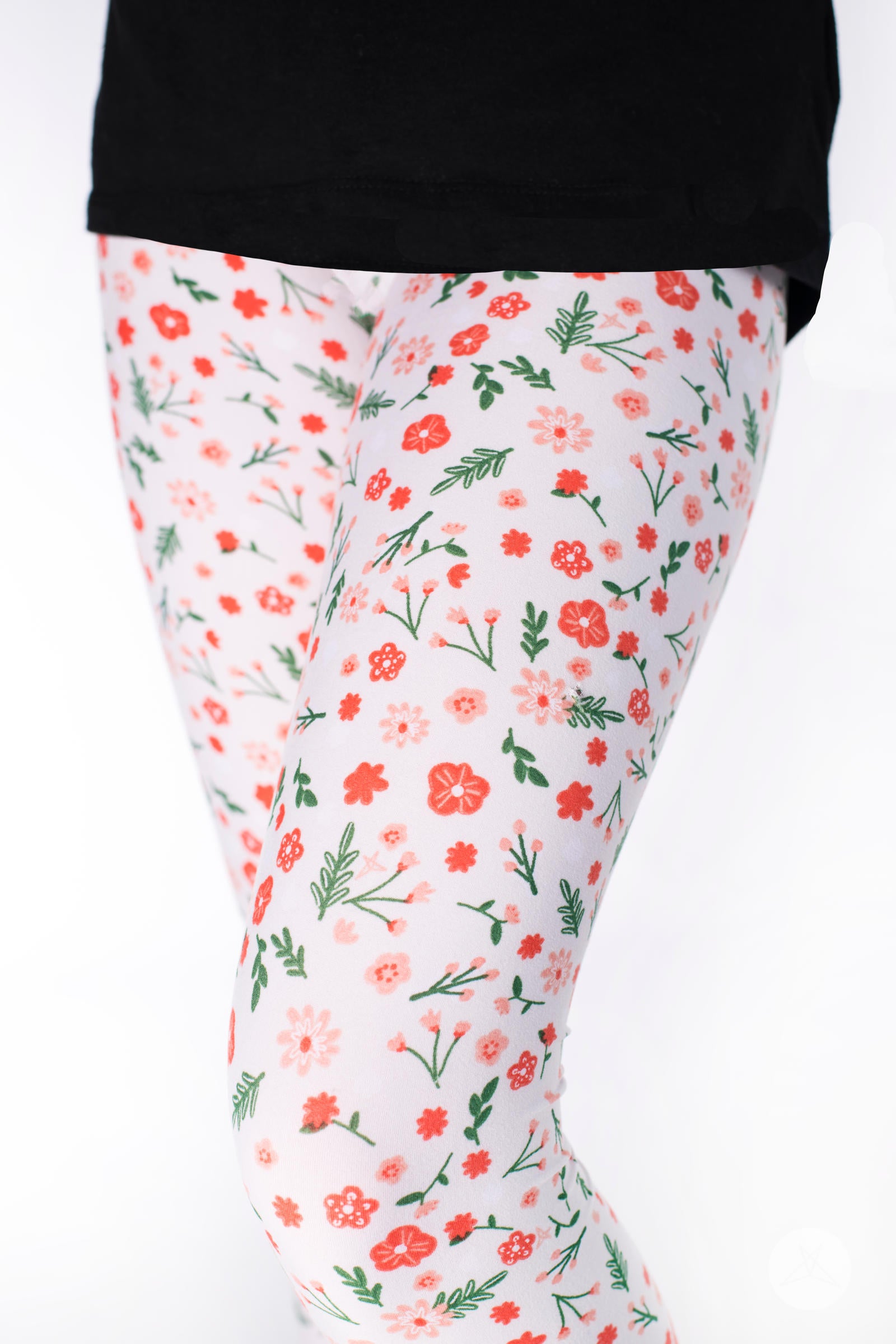 Flower Child Kids leggings by SweetLegs with coral and peach small flowers and green leaves on a light pearl background